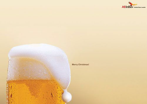 AB InBev "Merry Christmas" print ad — a beer glass with foam styled as a Santa hat